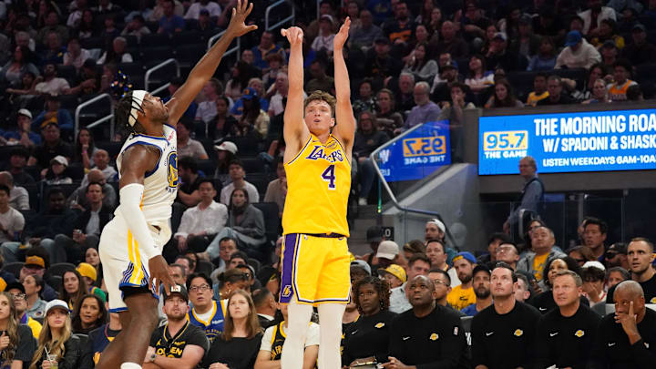 Oct 5, 2025; San Francisco, California, USA;  Los Angeles Lakers forward Dalton Knecht (4) shoots while defended by Golden State Warriors guard Buddy Hield (7) in the second quarter at Chase Center. Mandatory Credit: David Gonzales-Imagn Images
