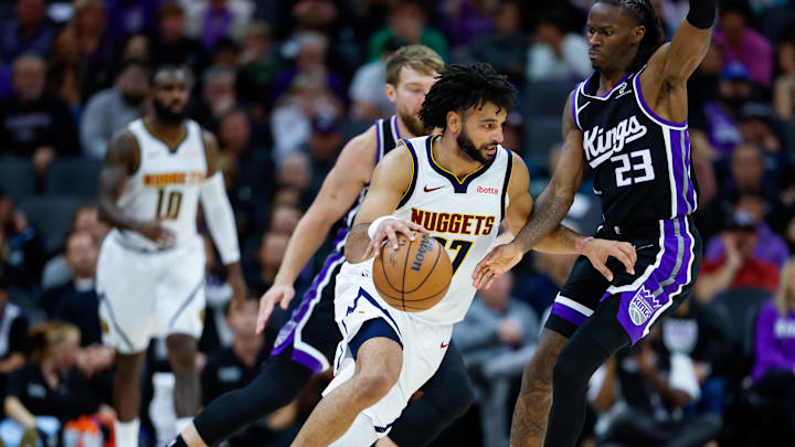Nov 11, 2025; Sacramento, California, USA; Denver Nuggets guard Jamal Murray (27) dribbles the ball against Sacramento Kings guard Keon Ellis (23) during the fourth quarter at Golden 1 Center. Mandatory Credit: Sergio Estrada-Imagn Images