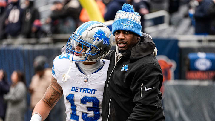 Detroit Lions running back Craig Reynolds (13) hugs assistant head coach and running backs coach Scottie Montgomery.