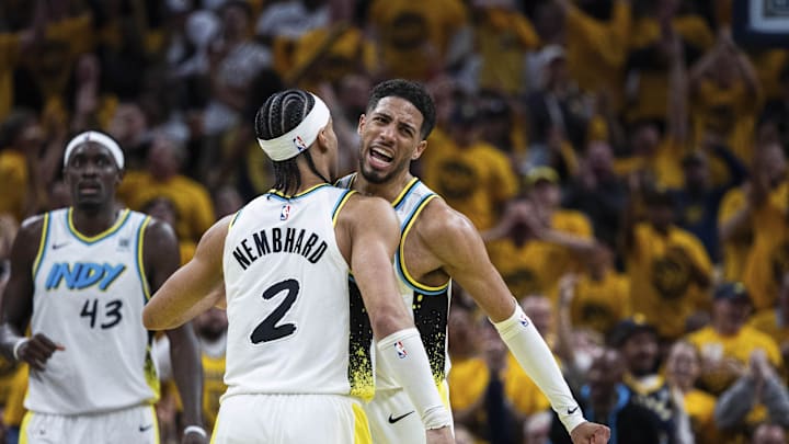 Apr 19, 2025; Indianapolis, Indiana, USA;  Indiana Pacers guard Andrew Nembhard (2) and guard Tyrese Haliburton (0) celebrate in the first half against the Milwaukee Bucks at Gainbridge Fieldhouse. Mandatory Credit: Trevor Ruszkowski-Imagn Images