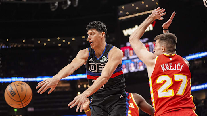 Jan 22, 2025; Atlanta, Georgia, USA; Detroit Pistons forward Simone Fontecchio (19) passes the ball against Atlanta Hawks guard Vit Krejci (27) during the first half at State Farm Arena. Mandatory Credit: Dale Zanine-Imagn Images