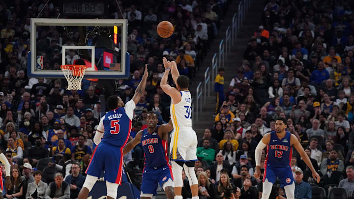 Mar 8, 2025; San Francisco, California, USA;  Golden State Warriors guard Stephen Curry (30) passes 25,000 career points after making a three-pointer over Detroit Pistons guard Malik Beasley (5) and center Jalen Duren (0) as forward Tobias Harris (12) looks on in the third quarter at Chase Center. Mandatory Credit: David Gonzales-Imagn Images
