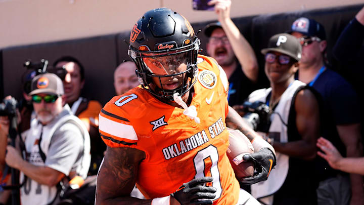 Oklahoma State's Ollie Gordon II (0) scores a touchdown in double over time of the college football game between the Oklahoma State Cowboys and the Arkansas Razorbacks at Boone Pickens Stadium in Stillwater, Okla.,, Saturday, Sept., 7, 2024. Oklahoma State's Ollie Gordon II (0) scores a touchdown in double over time of the college football game between the Oklahoma State Cowboys and the Arkansas Razorbacks at Boone Pickens Stadium in Stillwater, Okla.,, Saturday, Sept., 7, 2024.