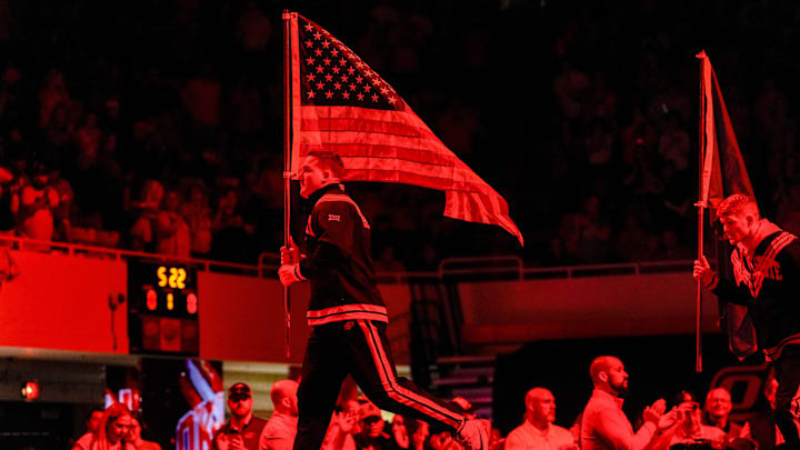 Oklahoma State’s Wyatt Hendrickson runs onto the mat with an American flag before an NCAA wrestling meet between Oklahoma State and Missouri at Gallagher-Iba Arena in Stillwater, Okla., on Sunday, Feb. 2, 2025.