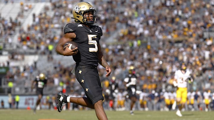 Oct 18, 2025; Orlando, Florida, USA; Central Florida Knights running back Jaden Nixon (5) rushes for an 83 yard touchdown in the second half against the West Virginia Mountaineers at Acrisure Bounce House. Mandatory Credit: Russell Lansford-Imagn Images Oct 18, 2025; Orlando, Florida, USA; Central Florida Knights running back Jaden Nixon (5) rushes for an 83 yard touchdown in the second half against the West Virginia Mountaineers at Acrisure Bounce House. Mandatory Credit: Russell Lansford-Imagn Images