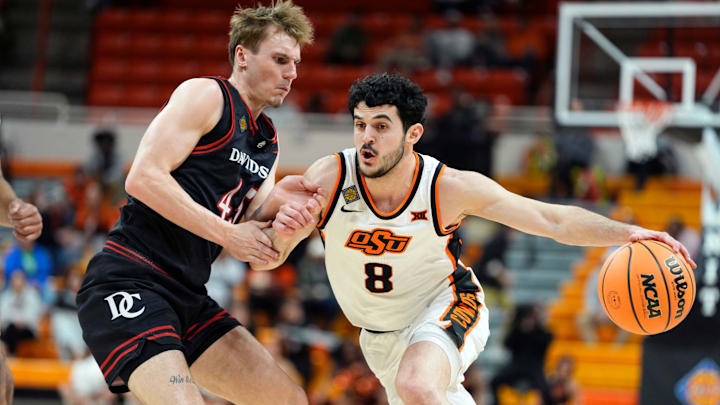 Oklahoma State Cowboys guard Daniel Guetta (8) dribbles beside Davidson Wildcats guard Roberts Blums (45) during a first-round basketball game in the National Invitational between the Oklahoma State Cowboys and the Davidson Wildcats at Gallagher-Iba Arena in Stillwater, Okla., Tuesday, March 17, 2026.