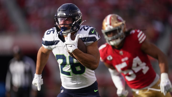 Dec 10, 2023; Santa Clara, California, USA; Seattle Seahawks running back Zach Charbonnet (26) runs past San Francisco 49ers linebacker Fred Warner (54) in the first quarter at Levi's Stadium. Mandatory Credit: Cary Edmondson-USA TODAY Sports