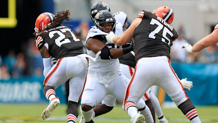 Cleveland Browns running back D'Onta Foreman (27) finds a lane past Jacksonville Jaguars defensive tackle Roy Robertson-Harris (95) held by Cleveland Browns guard Joel Bitonio (75) during the first quarter of an NFL football matchup Sunday, Sept. 15, 2024 at EverBank Stadium in Jacksonville, Fla. The Browns defeated the Jaguars 18-13. [Corey Perrine/Florida Times-Union]
