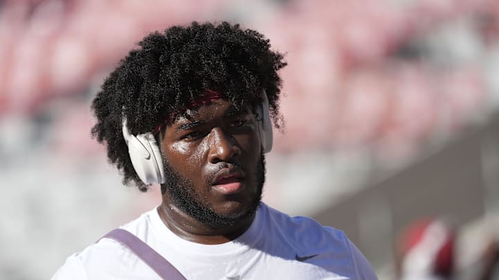 Oct 12, 2024; Tuscaloosa, Alabama, USA;  Alabama Crimson Tide offensive lineman Tyler Booker (52) completes his pregame stretch routine before playing South Carolina at Bryant-Denny Stadium.