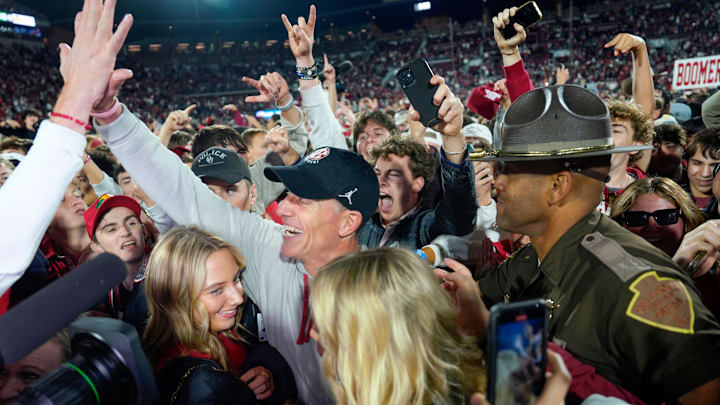 Oklahoma coach Brent Venables celebrates with fans after the Sooners knocked off Alabama in 2024.
