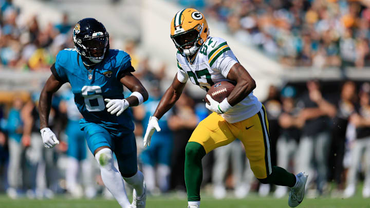 Green Bay Packers wide receiver Romeo Doubs (87) rushes for yards against Jacksonville Jaguars safety Darnell Savage (6) during the first quarter of an NFL football matchup Sunday, Oct. 27, 2024 at EverBank Stadium in Jacksonville, Fla. The Packers edged the Jaguars 30-27 on a last-second field goal. [Corey Perrine/Florida Times-Union]