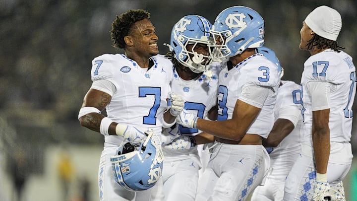 Sep 6, 2025; Charlotte, North Carolina, USA;  North Carolina Tar Heels defensive back Greg Smith (12) celebrates his interception with teammates during the second half against the Charlotte 49ers at Jerry Richardson Stadium. Mandatory Credit: Jim Dedmon-Imagn Images