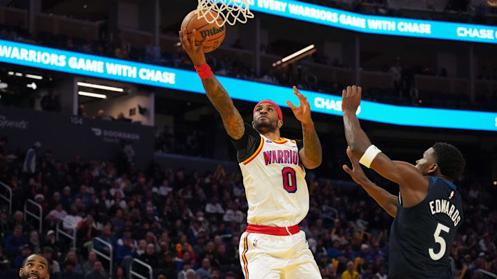 Golden State Warriors guard Gary Payton II makes a layup over Minnesota Timberwolves guard Anthony Edwards in the third quarter at Chase Center in San Francisco on Dec. 8, 2024.