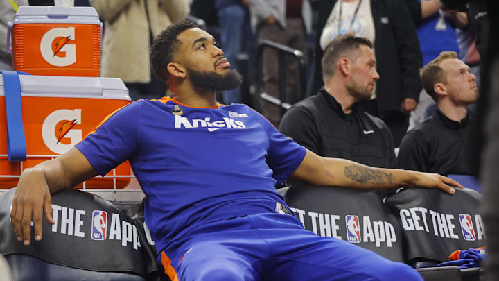 Dec 19, 2024; Minneapolis, Minnesota, USA; New York Knicks forward Karl-Anthony Towns (32) watches a tribute to him played by his former team, the Minnesota Timberwolves, before the game at Target Center. Mandatory Credit: Bruce Kluckhohn-Imagn Images