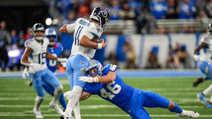 Tennessee Titans quarterback Mason Rudolph (11) tries to avoid being sacked by Detroit Lions linebacker Jack Campbell (46) during the first half of the NFL game at Ford Field in Detroit on Oct. 27, 2024.