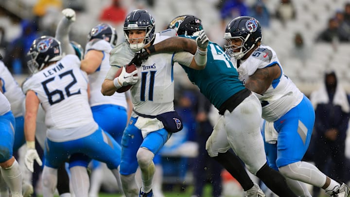 Jacksonville Jaguars defensive end Josh Hines-Allen (41) forces a fumble on Tennessee Titans quarterback Mason Rudolph (11) that was recovered by the offense during the second quarter of an NFL football matchup Sunday, Dec. 29, 2024 at EverBank Stadium in Jacksonville, Fla. [Corey Perrine/Florida Times-Union]