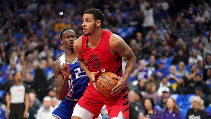 Apr 14, 2024; Sacramento, California, USA; Portland Trail Blazers forward Kris Murray (8) holds onto the ball in front of Sacramento Kings guard Keon Ellis (23) in the first quarter at the Golden 1 Center. Mandatory Credit: Cary Edmondson-Imagn Images