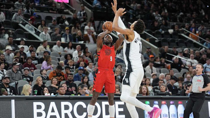 Dec 21, 2024; San Antonio, Texas, USA;  Portland Trail Blazers forward Jerami Grant (9) shoots the ball against San Antonio Spurs center Victor Wembanyama (1) in the first half at Frost Bank Center. Mandatory Credit: Daniel Dunn-Imagn Images