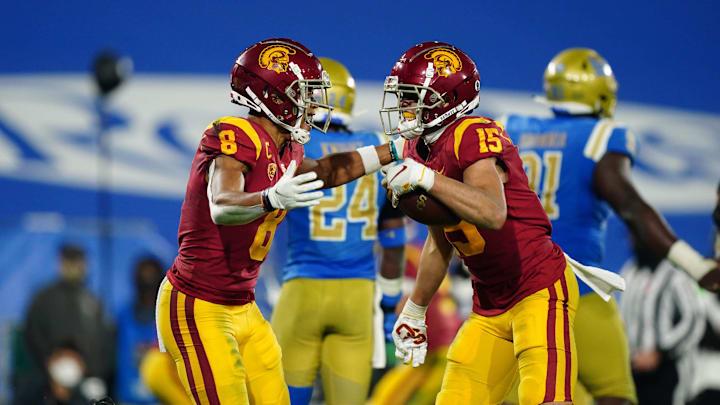 Dec 12, 2020; Pasadena, California, USA; Southern California Trojans wide receiver Drake London (15) celebrates with wide receiver Amon-Ra St. Brown (8) after catching a 9-yard touchdown reception in the fourth quarter against the UCLA Bruins at Rose Bowl. USC defeated UCLA 43-38.  Mandatory Credit: Kirby Lee-Imagn Images