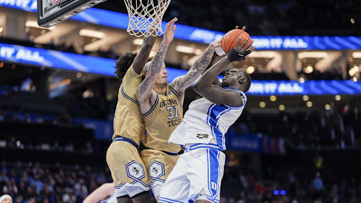 Mar 13, 2025; Charlotte, NC, USA;  Duke Blue Devils center Khaman Maluach (9) goes to the basket against Georgia Tech Yellow Jackets forward Duncan Powell (31) during the second half at Spectrum Center. Mandatory Credit: Jim Dedmon-Imagn Images