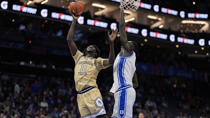 Mar 13, 2025; Charlotte, NC, USA; Georgia Tech Yellow Jackets forward Baye Ndongo (11) on a fast break play against Duke Blue Devils center Khaman Maluach (9) during the first half at Spectrum Center. Mandatory Credit: Jim Dedmon-Imagn Images