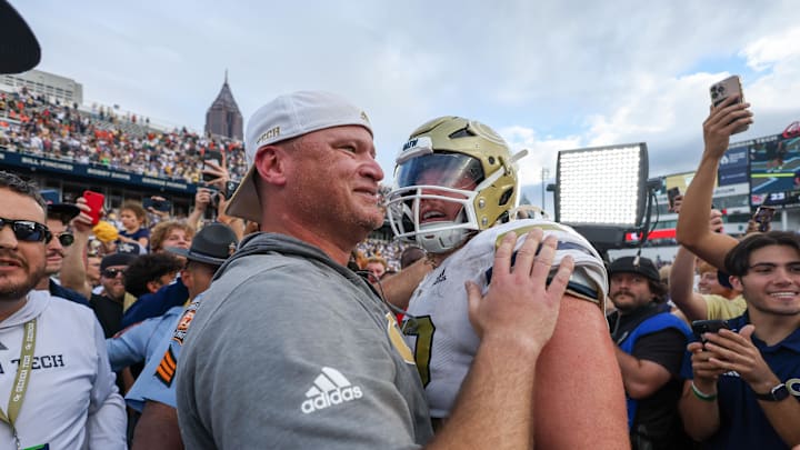 Nov 9, 2024; Atlanta, Georgia, USA; Georgia Tech Yellow Jackets head coach Brent Key hugs offensive lineman Weston Franklin (72) after a victory over the Miami Hurricanes at Bobby Dodd Stadium at Hyundai Field. Mandatory Credit: Brett Davis-Imagn Images
