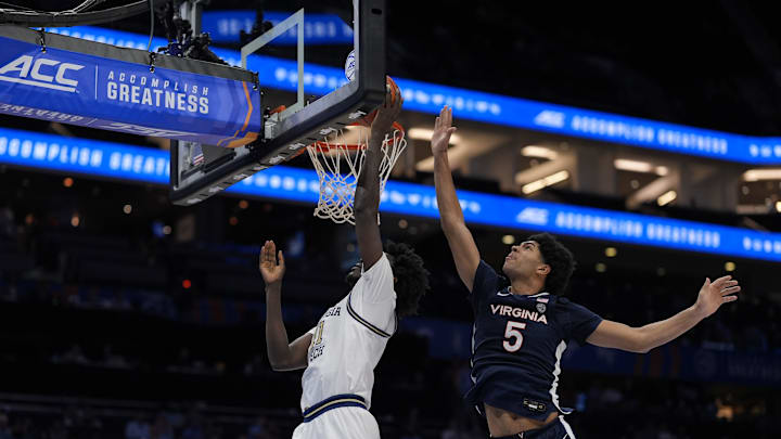 Mar 12, 2025; Charlotte, NC, USA; Georgia Tech Yellow Jackets forward Baye Ndongo (11) goes to the basket defended by Virginia Cavaliers forward Jacob Cofie (5) during the second half at Spectrum Center. Mandatory Credit: Jim Dedmon-Imagn Images