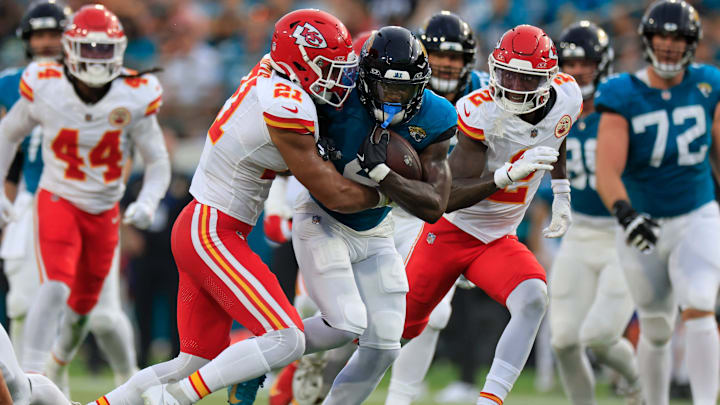 Jacksonville Jaguars running back Tank Bigsby (4) is tackled by Kansas City Chiefs safety Jaden Hicks (21) as cornerback Joshua Williams (2) looks on during the first quarter of a preseason NFL football game Saturday, Aug. 10, 2024 at EverBank Stadium in Jacksonville, Fla. [Corey Perrine/Florida Times-Union]