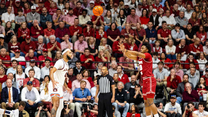 Feb 15, 2025; Tuscaloosa, Alabama, USA; Alabama Crimson Tide forward Mouhamed Dioubate (10) passes the ball against Auburn Tigers forward Johni Broome (4) during the first half at Coleman Coliseum. 