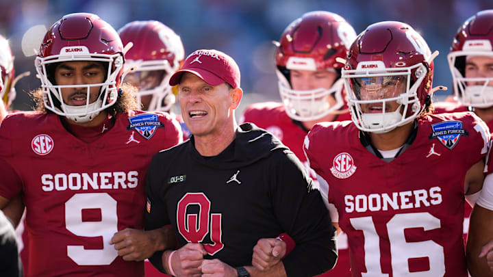 Oklahoma coach Brent Venables locks arms with players before the Armed Forces Bowl football game between the University of Oklahoma Sooners (OU) and the Navy Midshipmen at Amon G. Carter Stadium in Fort Worth, Texas, Friday, Dec. 27, 2024. Navy won 21-20.