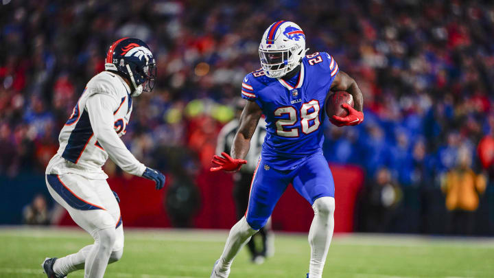 Nov 13, 2023; Orchard Park, NY; Buffalo Bills running back Latavius Murray (28) runs with the ball against Denver Broncos cornerback Fabian Moreau (23) during the first half at Highmark Stadium. 
