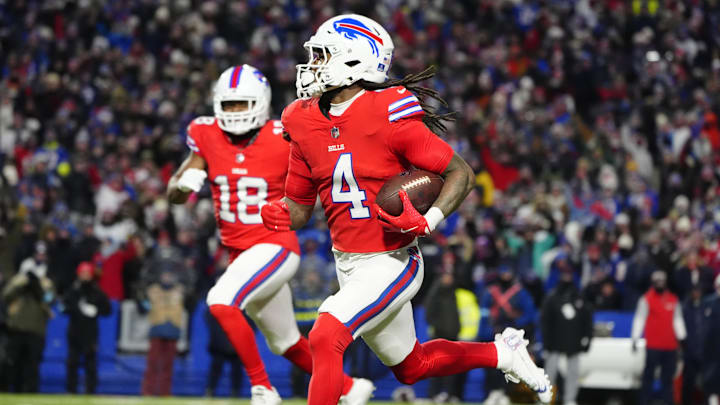 Dec 22, 2024; Orchard Park, New York, USA; Buffalo Bills running back James Cook (4) runs with the ball for a touchdown against the New England Patriots during the first half at Highmark Stadium.