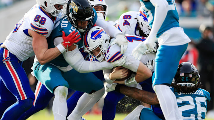 Buffalo Bills quarterback Josh Allen (17), center, is short of the goal line as Jacksonville Jaguars defensive tackle Arik Armstead (91) and safety Antonio Johnson (26) make the stop during the fourth quarter of an NFL football AFC Wild Card playoff matchup, Sunday, Jan. 11, 2026, in Jacksonville, Fla. The Bills defeated the Jaguars 27-24. [Corey Perrine/Florida Times-Union]