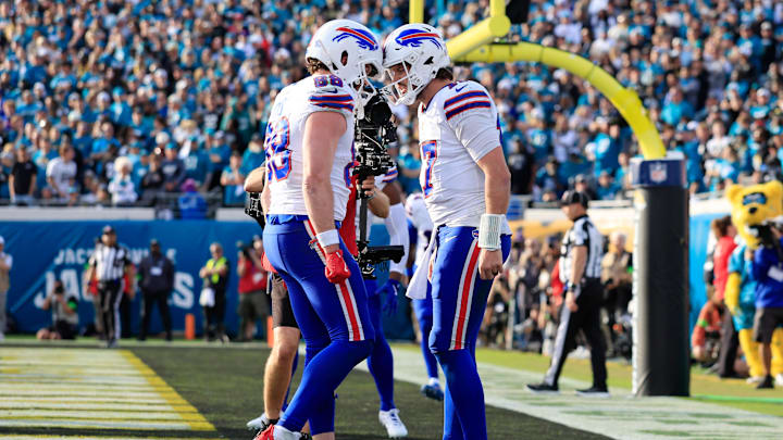 Buffalo Bills quarterback Josh Allen (17), right, celebrates his touchdown with teammate tight end Dawson Knox (88) during the fourth quarter of an NFL football AFC Wild Card playoff matchup, Sunday, Jan. 11, 2026, in Jacksonville, Fla.