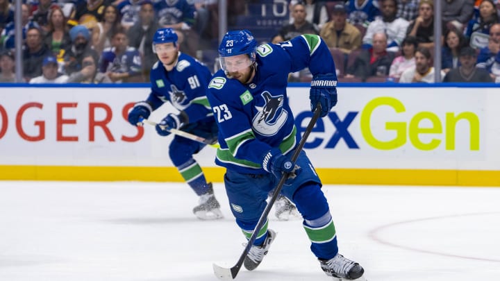 May 20, 2024; Vancouver, British Columbia, CAN; Vancouver Canucks forward Elias Lindholm (23) handles the puck against the Edmonton Oilers during the first period in game seven of the second round of the 2024 Stanley Cup Playoffs at Rogers Arena. Mandatory Credit: Bob Frid-USA TODAY Sports