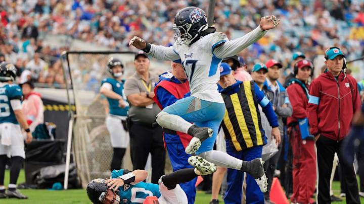 Tennessee Titans linebacker Jerome Baker (17) leaps to avoid collision with Jacksonville Jaguars quarterback Mac Jones (10) during the fourth quarter Sunday, Dec. 29, 2024 at EverBank Stadium in Jacksonville, Fla. The Jaguars held off the Titans 20-13. [Corey Perrine/Florida Times-Union]