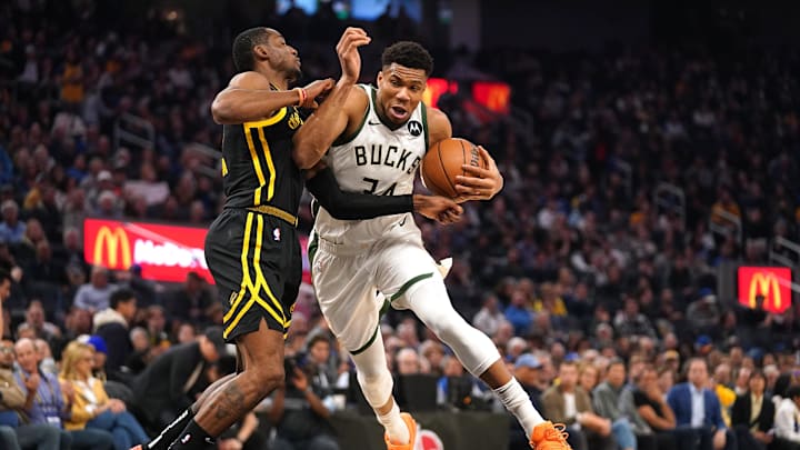 Mar 6, 2024; San Francisco, California, USA; Milwaukee Bucks forward Giannis Antetokounmpo (34) drives past Golden State Warriors forward Jonathan Kuminga (00) in the second quarter at the Chase Center. Mandatory Credit: Cary Edmondson-Imagn Images
