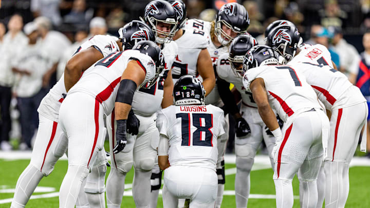Nov 10, 2024; New Orleans, Louisiana, USA;   Atlanta Falcons quarterback Kirk Cousins (18) calls a play in the huddle against the New Orleans Saints during the first half at Caesars Superdome. Mandatory Credit: Stephen Lew-Imagn Images