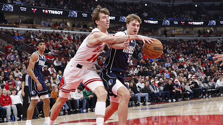 Jan 10, 2026; Chicago, Illinois, USA; Chicago Bulls forward Matas Buzelis (14) battles for the ball with Dallas Mavericks forward Cooper Flagg (32) during the first half at United Center. Mandatory Credit: Kamil Krzaczynski-Imagn Images