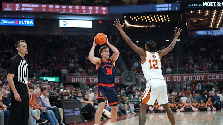 Dec 3, 2025; Austin, Texas, USA; Virginia Cavaliers guard Dallin Hall (30) looks to pass against Texas Longhorns guard Tramon Mark (12) during the second half at Moody Center. Mandatory Credit: Dustin Safranek-Imagn Images