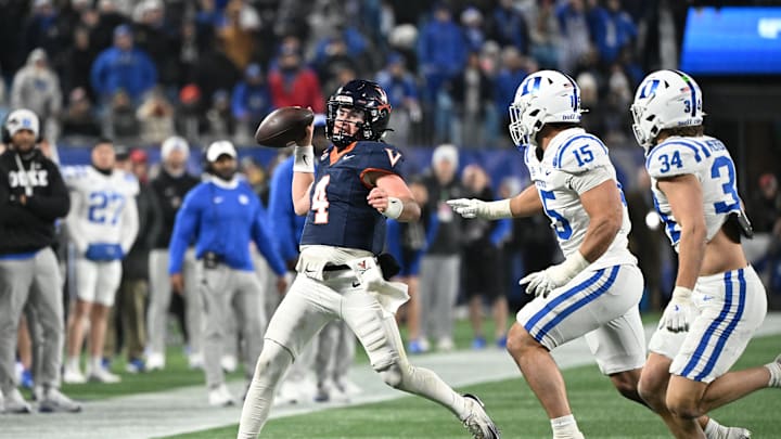 Dec 6, 2025; Charlotte, NC, USA; Virginia Cavaliers quarterback Chandler Morris (4) passes the ball as Duke Blue Devils defensive end Kevin O'Connor (15) and linebacker Luke Mergott (34) pressure in the fourth quarter during the ACC Championship game at Bank of America Stadium. Mandatory Credit: Bob Donnan-Imagn Images