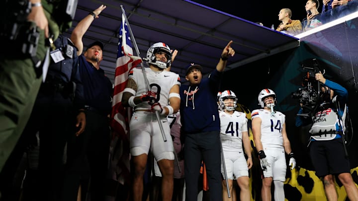 Virginia Cavaliers safety Antonio Clary (0) is talked to by head coach Tony Elliott before running on the field before the first quarter of the TaxSlayer Gator Bowl at EverBank Stadium, Saturday, Dec. 27, 2025, in Jacksonville. Fla. [Corey Perrine/Florida Times-Union]
