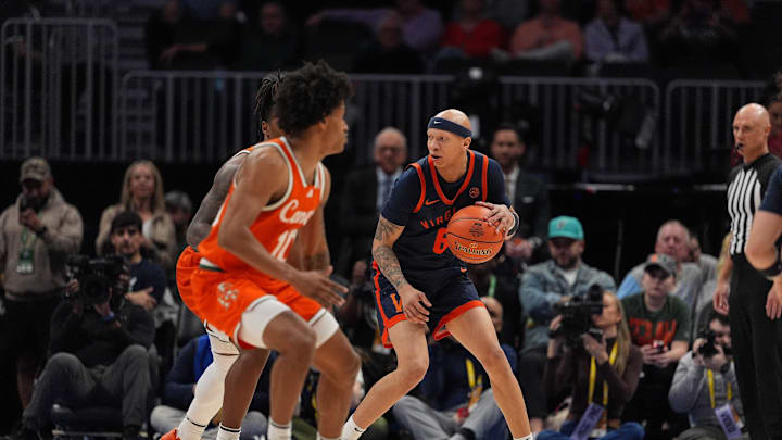 Mar 13, 2026; Charlotte, NC, USA; Virginia Cavaliers guard Jacari White (6) handles the ball against Miami Hurricanes guard Tru Washington (10) during the second half at Spectrum Center. Mandatory Credit: Jim Dedmon-Imagn Images
