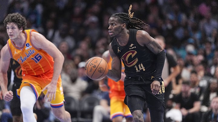 Feb 20, 2026; Charlotte, North Carolina, USA;  Cleveland Cavaliers guard Keon Ellis (14) dribbles against Charlotte Hornets center PJ Hall (16) during the second half at the Spectrum Center. Mandatory Credit: Jim Dedmon-Imagn Images