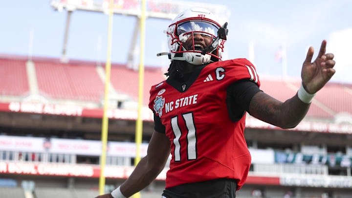 Tampa, FL, USA; NC State Wolfpack quarterback CJ Bailey (11) runs into the end zone for a touchdown against the Memphis Tigers in the first quarter during the Gasparilla Bowl at Raymond James Stadium.