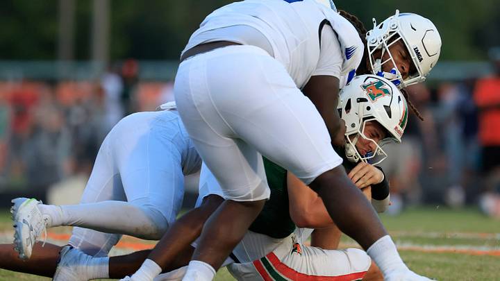 Mandarin's Knox Annis (8), center, is tackled by IMG Academy's Censere Gayloard (21), center back, along with Zyron Forstall (0), left, and Joseph Graves (75), top, during the second quarter of a high school football matchup at Mandarin High School, Friday, Sept. 19, 2025, in Jacksonville, Fla. The IMG Academy Ascenders defeated the Mandarin Mustangs 57-7. Mandarin's Knox Annis (8), center, is tackled by IMG Academy's Censere Gayloard (21), center back, along with Zyron Forstall (0), left, and Joseph Graves (75), top, during the second quarter of a high school football matchup at Mandarin High School, Friday, Sept. 19, 2025, in Jacksonville, Fla. The IMG Academy Ascenders defeated the Mandarin Mustangs 57-7.