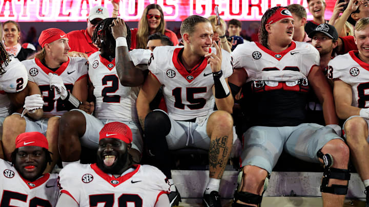 Georgia Bulldogs quarterback Carson Beck (15) smiles as defensive lineman Nazir Stackhouse (78) hangs out his tongue after the game of an NCAA football game Saturday, Oct. 28, 2023 at EverBank Stadium in Jacksonville, Fla. Georgia defeated Florida 43-20. [Corey Perrine/Florida Times-Union]
