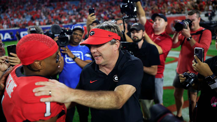 Georgia Bulldogs head coach Kirby Smart talks with running back Trevor Etienne (1) after the game of an NCAA college football matchup Saturday, Nov. 2, 2024 at EverBank Stadium in Jacksonville, Fla. The Georgia Bulldogs defeated the Florida Gators 34-20. [Corey Perrine/Florida Times-Union]