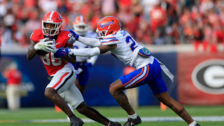 Georgia Bulldogs wide receiver Dillon Bell (86) is pressured by Florida Gators defensive back Dijon Johnson (27) during the first quarter of an NCAA college football matchup Saturday, Nov. 2, 2024 at EverBank Stadium in Jacksonville, Fla. The Georgia Bulldogs defeated the Florida Gators 34-20. [Corey Perrine/Florida Times-Union]