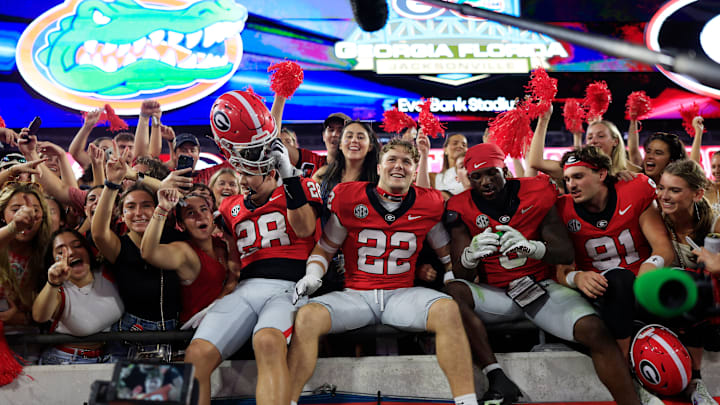 Georgia Bulldogs wide receiver Walter Blanchard (28), defensive back Jake Pope (22), Georgia Bulldogs running back Nate Frazier (3) and place kicker Peyton Woodring (91) celebrate after the game of an NCAA college football matchup Saturday, Nov. 2, 2024 at EverBank Stadium in Jacksonville, Fla. The Georgia Bulldogs defeated the Florida Gators 34-20. [Corey Perrine/Florida Times-Union]